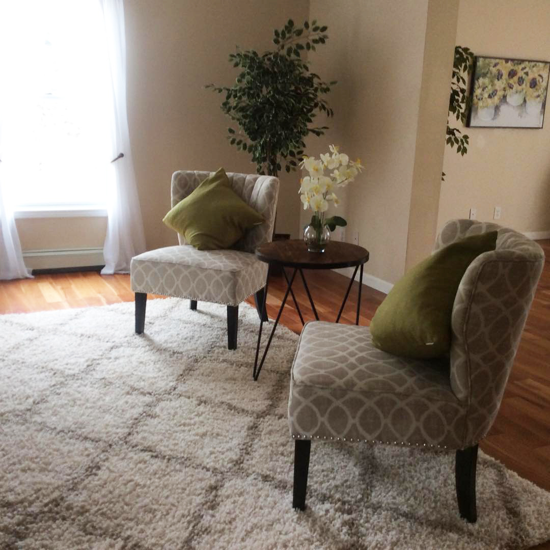 Staged Living Room with Chairs and Throw Pillows